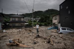 Japan rescuers go house to house as flood toll hits 141.jpg Japan rescuers go house to house as flood toll hits 141.jpg