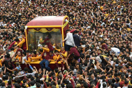 Philippine Catholics swarm Christ icon in feverish parade.jpg