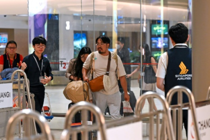 Relieved travellers land in Singapore after deadly turbulence.jpg