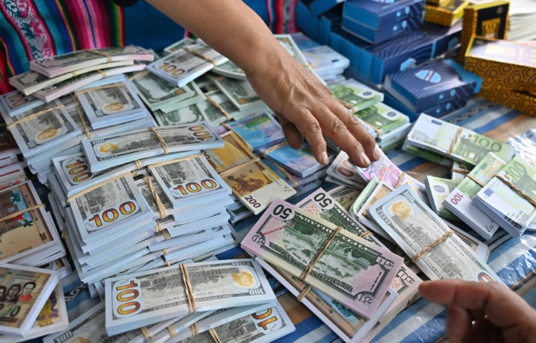 Facing Bolivia's economic crunch with toy houses, fake banknotes