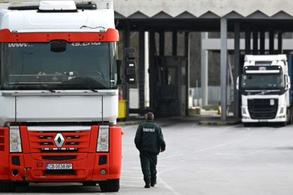 Lorries wait at a border crossing between Bulgaria and Greece, where controls will end as Romania and Bulgaria join the Schengen zone at midnight