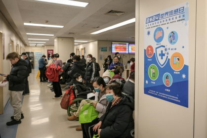 People wearing masks wait in the respiratory department of a Beijing hospital this week