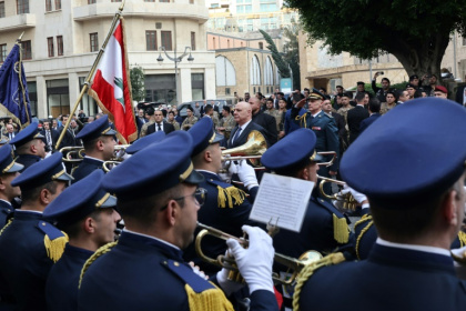 Aoun stands to attention outside the parliament building in Beirut