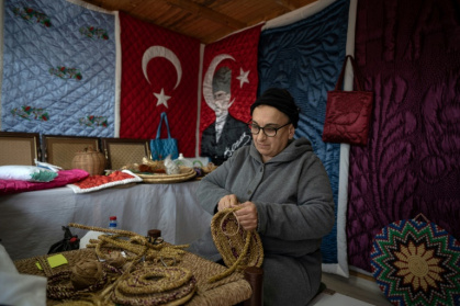 Traditional quilt artist Nahya Guzelyurt works in the Antakya Art and Culture Market