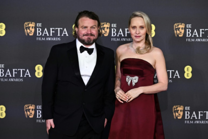 US director Brady Corbet and his wife Mona Fastvold pose on the red carpet before he won the BAFTA for best director