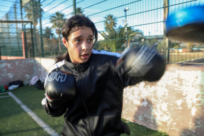 A young woman practices boxing drills at a sports complex in Algier