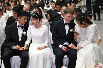 Couples attending a mass wedding ceremony organised by the Unification Church at Cheongshim Peace World Center in Gapyeong Couples attending a mass wedding ceremony organised by the Unification Church at Cheongshim Peace World Center in Gapyeong