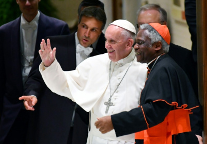 Pope Francis is flanked by Ghana's Cardinal Peter Turkson at the Vatican in 2016 Pope Francis is flanked by Ghana's Cardinal Peter Turkson at the Vatican in 2016