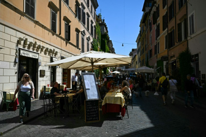 In the lively via Borgo Pio in the shadow of the Vatican, tourists pack into typical Roman restaurants and tacky souvenir shops - Gabriel BOUYS In the lively via Borgo Pio in the shadow of the Vatican, tourists pack into typical Roman restaurants and tacky souvenir shops - Gabriel BOUYS