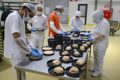 Employees at the Halk Ekmek bakery mix and cut dough for Kulluoba bread, recreating a 5,000-year-old loaf - Yasin AKGUL (AFP) Employees at the Halk Ekmek bakery mix and cut dough for Kulluoba bread, recreating a 5,000-year-old loaf - Yasin AKGUL (AFP)