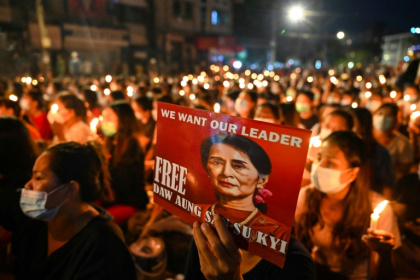 A protester holds a poster of Aung San Suu Kyi during a candlelight vigil to honour those who have died during demonstrations against the military coup in Yangon on March 13, 2021 - STR (AFP) A protester holds a poster of Aung San Suu Kyi during a candlelight vigil to honour those who have died during demonstrations against the military coup in Yangon on March 13, 2021 - STR (AFP)