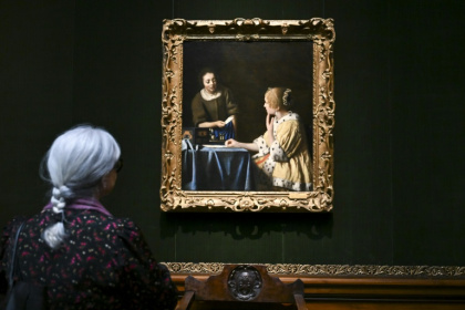 A woman views 'Mistress and Maid' by Johannes Vermeer at the Frick Collection in New York - ANGELA WEISS (AFP) A woman views 'Mistress and Maid' by Johannes Vermeer at the Frick Collection in New York - ANGELA WEISS (AFP)
