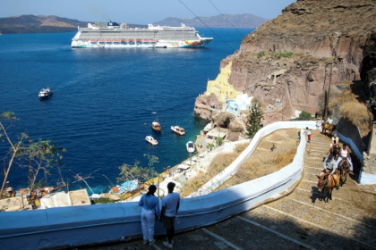 A cruise ship off the Greek island of Santorini, which is among the destinations for which cruise ships will now pay tourist taxes - ARIS OIKONOMOU (AFP) A cruise ship off the Greek island of Santorini, which is among the destinations for which cruise ships will now pay tourist taxes - ARIS OIKONOMOU (AFP)