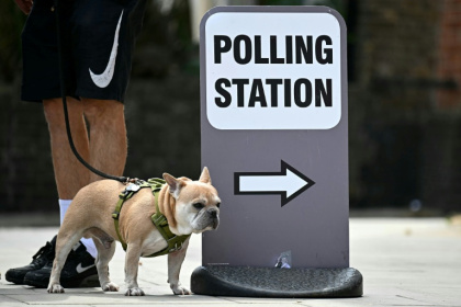 A dog stands by a polling station sign in Hackney, east London, on July 4, 2024 when Britain held its last general elections - Paul ELLIS (AFP) A dog stands by a polling station sign in Hackney, east London, on July 4, 2024 when Britain held its last general elections - Paul ELLIS (AFP)