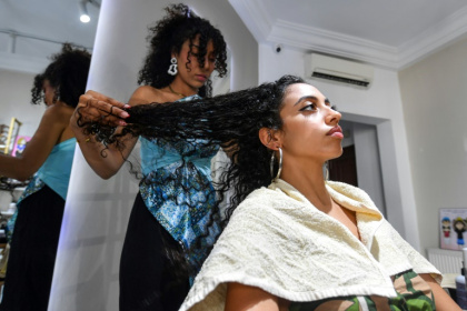 Many Tunisian women are embracing natural hairstyles, bucking a longstanding social stigma around curls - FETHI BELAID (AFP)
