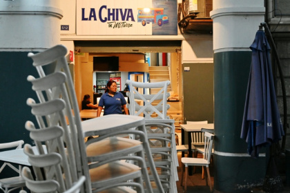 A waitress works during closing time at a restaurant in Guayaquil, Ecuador, where local mafias have violently shut down the party in the traditional red-light districts - MARCOS PIN (AFP) A waitress works during closing time at a restaurant in Guayaquil, Ecuador, where local mafias have violently shut down the party in the traditional red-light districts - MARCOS PIN (AFP)
