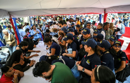Thousands line up to join the civilian militia in Venezuela after President Nicolas Maduro warned of possible US invasion - Juan BARRETO (AFP) Thousands line up to join the civilian militia in Venezuela after President Nicolas Maduro warned of possible US invasion - Juan BARRETO (AFP)