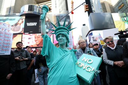 A person dressed in a Statue of Liberty costume participates in a 'No Kings' protest in New York - TIMOTHY A.CLARY (AFP) A person dressed in a Statue of Liberty costume participates in a 'No Kings' protest in New York - TIMOTHY A.CLARY (AFP)