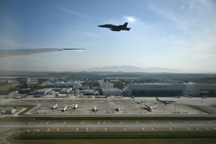 A Malaysian F-18 escort plane is seen from the cabin of Air Force One as it prepares to land at Kuala Lumpur - ANDREW CABALLERO-REYNOLDS (AFP) A Malaysian F-18 escort plane is seen from the cabin of Air Force One as it prepares to land at Kuala Lumpur - ANDREW CABALLERO-REYNOLDS (AFP)