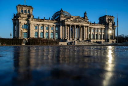 Berlin's Reichstag building, which houses the lower house of parliament, is reflected in a sheet of ice - John MACDOUGALL (AFP)