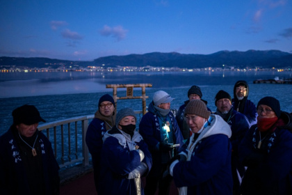 A Japanese priest and his parishioners gather before dawn, hoping climate change hasn't robbed them of a rare communion with the sacred - Philip FONG (AFP)