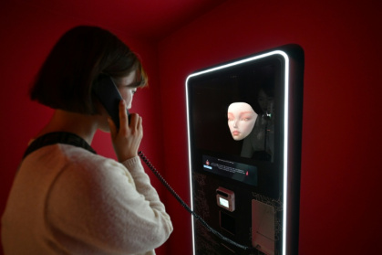 A woman speaking with an artificial intelligence-assisted shaman robot - Jung Yeon-je (AFP)