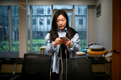 SoloNest founder Karen Dai preparing a coffee chat at a conference room in Shanghai - Jade GAO (AFP)