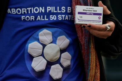 An abortion rights activist holds a box of mifepristone during a rally in front of the US Supreme Court on March 26, 2024, in Washington, DC - Drew ANGERER (AFP)