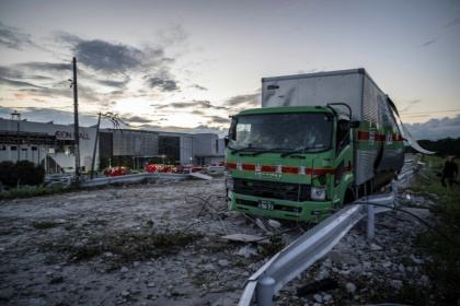 A damaged truck is seen on a debris-covered road in Kashima, Kumamoto Prefecture - Yuichi YAMAZAKI (AFP)