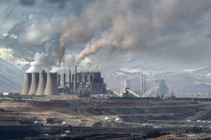 Mining vehicles extract coal from a lignite coal mine, as the Elbistan thermal power plant, is seen in the background in Elbistan on February 11, 2026 - Ozan KOSE (AFP)